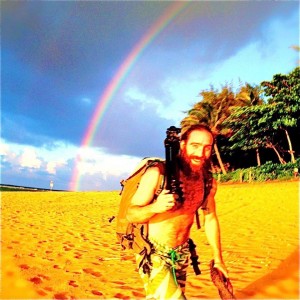 Aaron Feinberg being chased by a rainbow while on at Tunnels, Kauai.