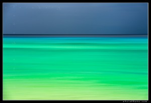 Abstract of ocean with turquoise water and dark sky at Polihale State Park
