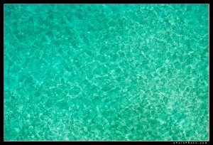 Looking through clear turquoise water from above