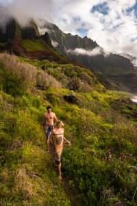 Wedding couple makes there way down the Kalalau trail with dramatic light