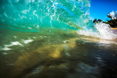 In water photography of mini barrel wave with shore break Lumahai Beach, Kauai, Hawaii