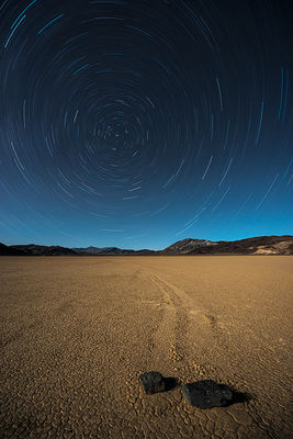 Moving rocks under star trails in Death Valley National Park, California