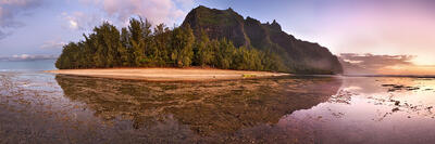 A 180 degree panoramic view of Ke'e Beach with full moon rising to the east and sunset to the west down the Na Pali Coast, Kauai, Hawaii