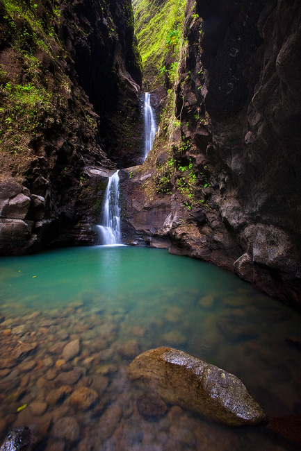Lush tropical jungle waterfalls in emerald pool below Makaleha Falls, Kauai, Hawaii 
