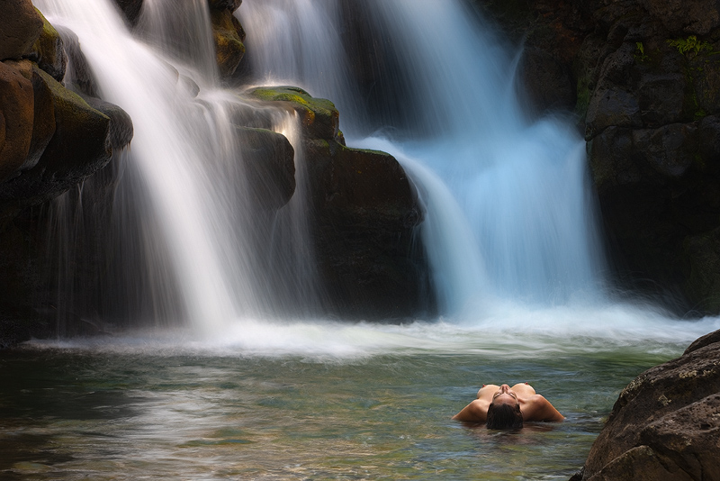 fine art landscape nude of beautiful woman in waters of Ho'opi'i Falls, Kauai, Hawaii 