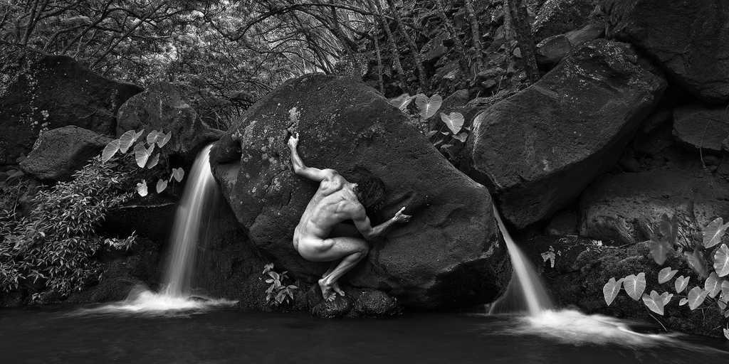 black and white fine art landscape nude rock climbing over the water, Miloli'i, Kauai, Hawaii 