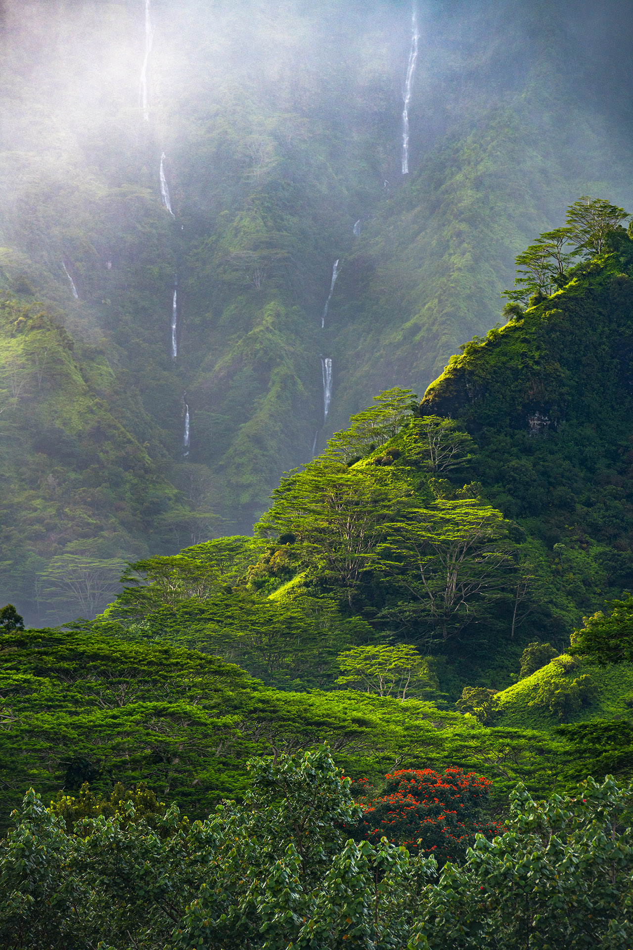 Incredibly dramatic light, clouds and waterfalls of Makaleha above Kapaa, Kauai, Hawaii.