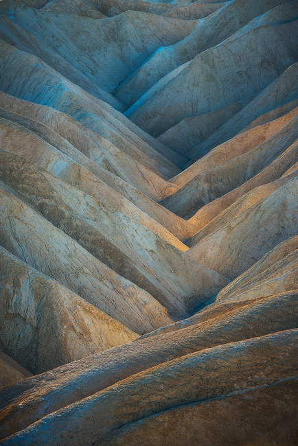 Earthworks Natural abstract colors looking like gears of earth with reflected light in Death Valley National Park, California